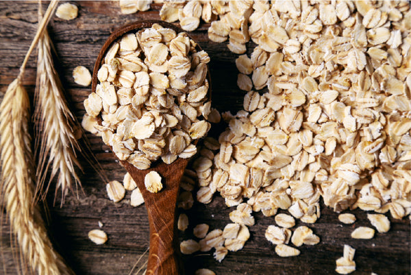 DIY oat milk represented by a spoonful of oats