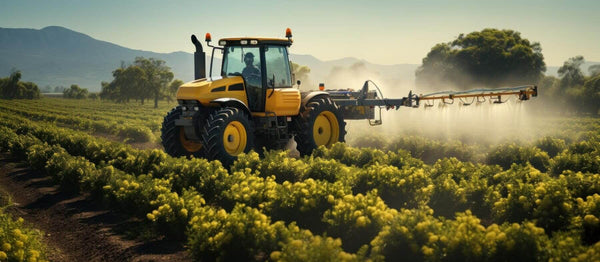 Tractor spraying oat crops with glyphosate