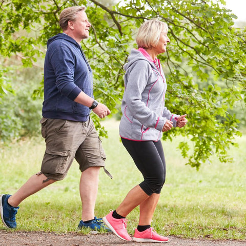 Couple brisk walking at the park