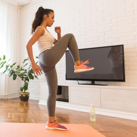 Fit woman exercising in living room home workout