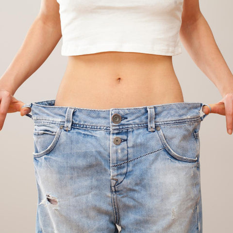 Weight loss. Woman in oversized pants