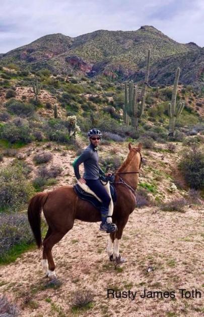 Top endurance rider Rusty Toth on his sorrel horse in the mountain desert riding in a Freeform treeless saddle.