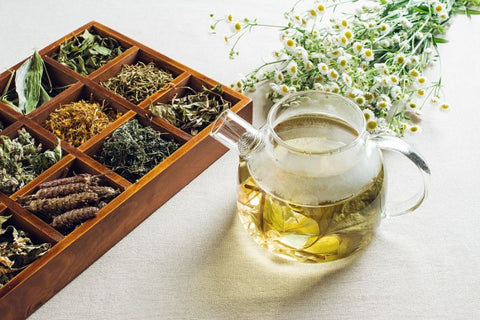 selection of herbal teas and a glass teapot