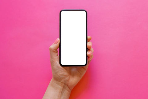 barbie pink background and phone with bright white screen