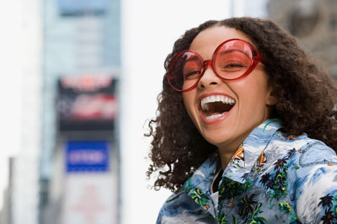 girl laughing in sunglasses