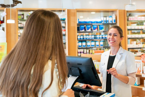 blue light blocking glasses pharmacy counter woman smiling