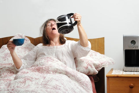 woman in bed drinking entire pot of coffee