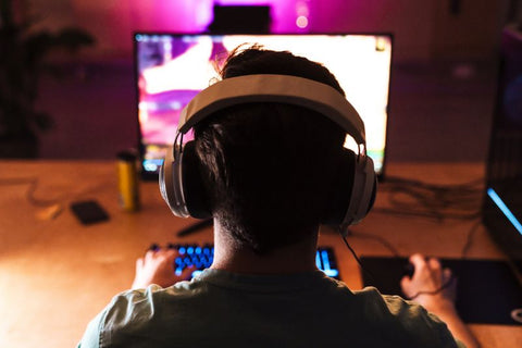 gamer playing with headset over nice backlight