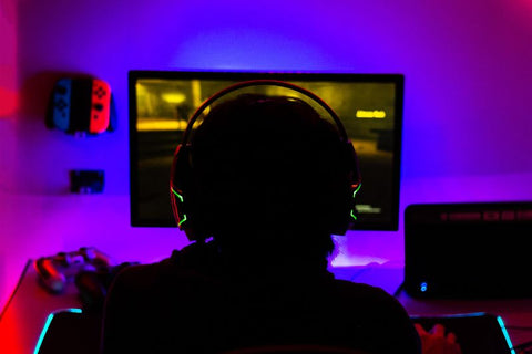 Gamer in front of his monitor with rgb back lights