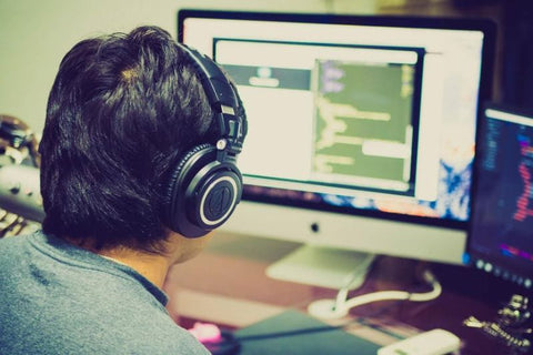 Gamer playing with great headphones in front of his screen