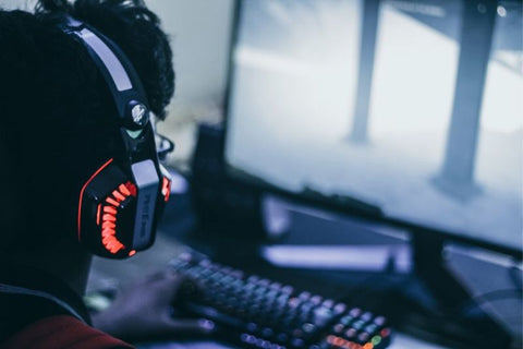 Gamer in front of a screen with cool lit headset