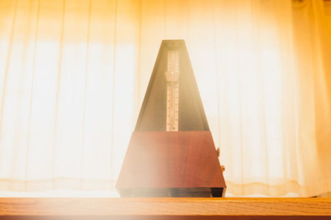 a metronome with light behind it