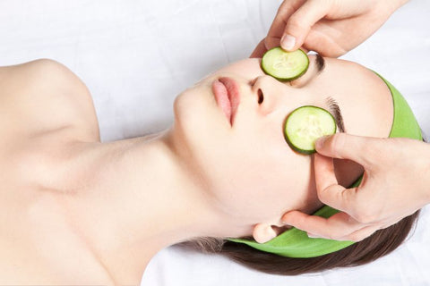 woman with cucumber over eyes
