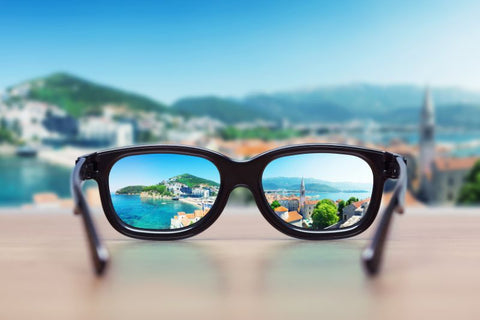 glasses with stunning vista through frames and blurred background