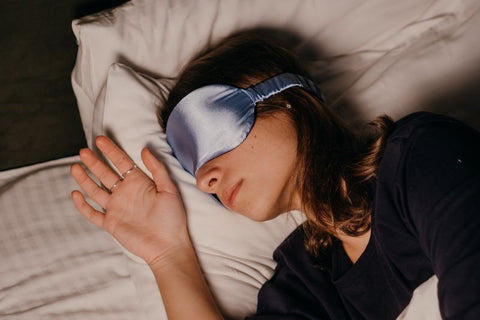 woman using face mask as an accessory for better sleep