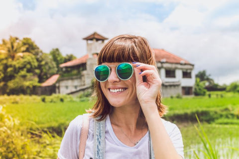 woman wearing sunglasses in field