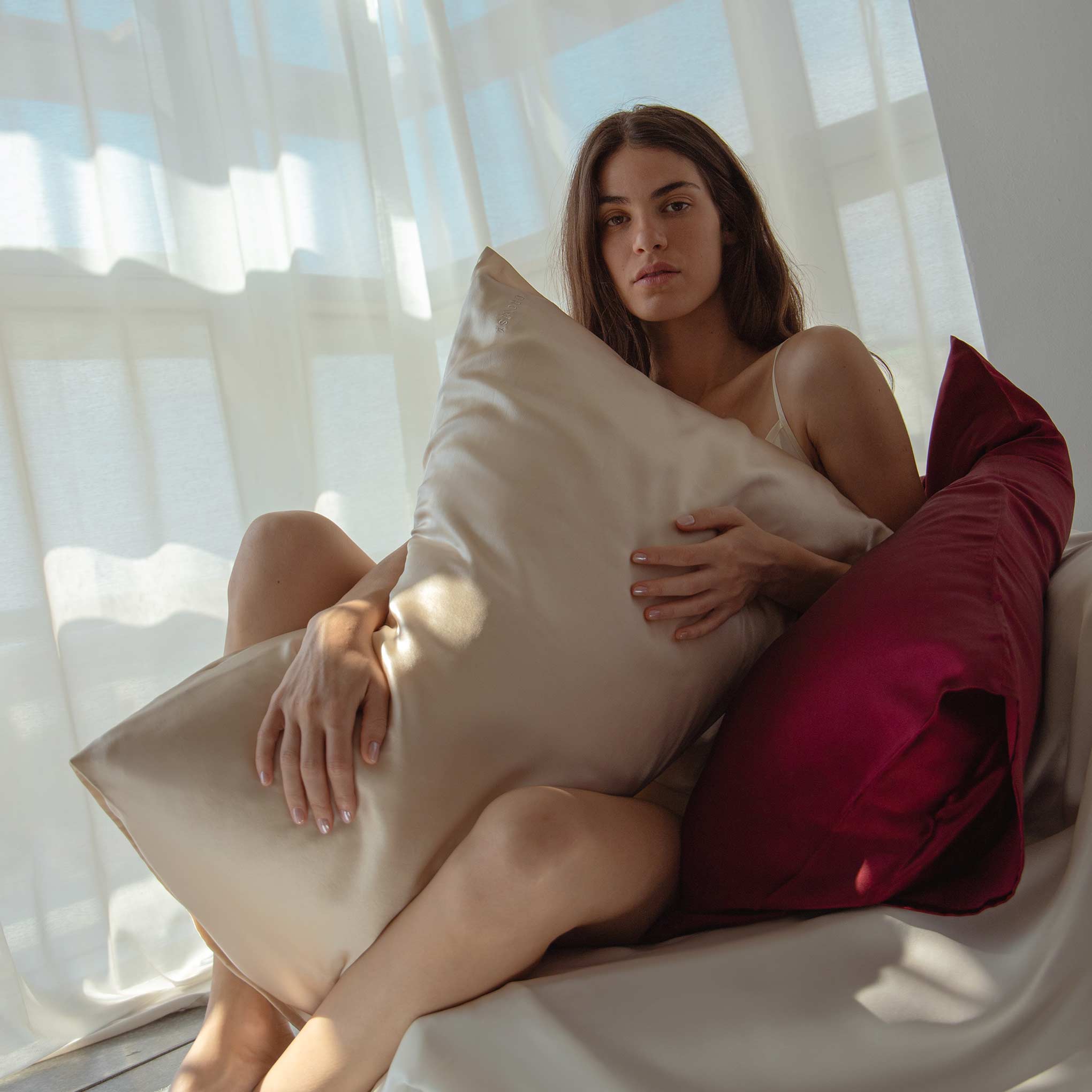 Female model holding baby blue coloured Drowsy Silk Pillowcase
