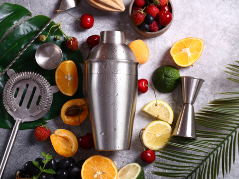 cocktail shakers with fruits all around it