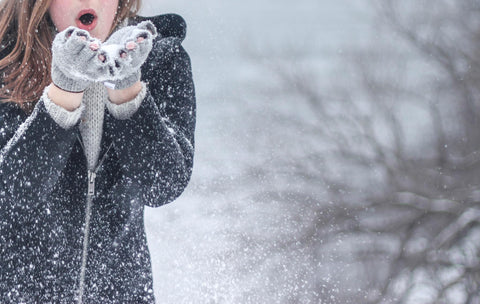 Girl holding ice snow in hands