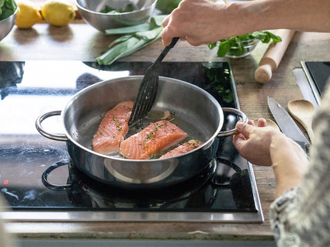 Salmon cooking on a stove