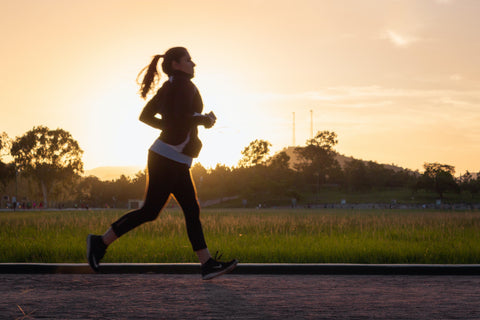 Woman running during sunrise