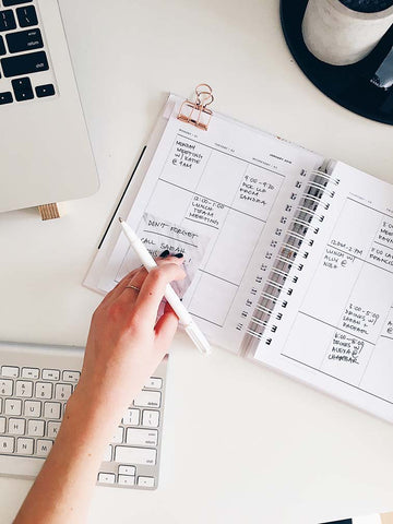 Laptop and planner on desk