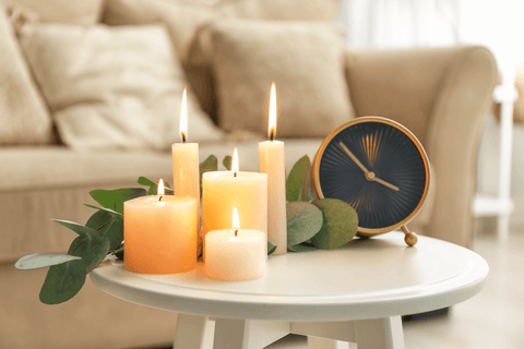 Beautiful Burning Candles and Clock on Table