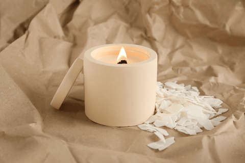 Burning Soy Candle and Wax Flakes on Crumpled Kraft Paper