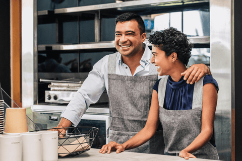 happy couple cooking in a kitchen