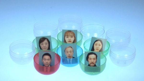 Unsmiling Strangers in a Plastic Ball