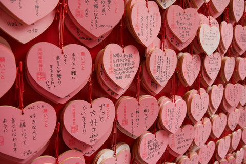 One tradition in Japan for couples is to write wishes about their relationship on an Ema (wishing wooden plaques), and hanging them in a shrine, in the hopes of making their wishes come true.