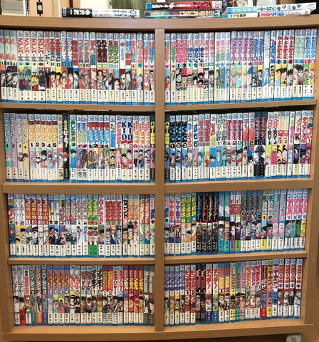 a bookshelf full of manga comics