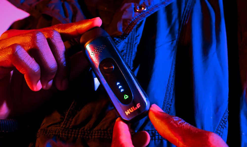 Man holding Wulf Next under purple and blue studio lighting