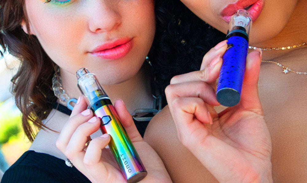 Two women holding Wulf Orbit at a park with natural lighting