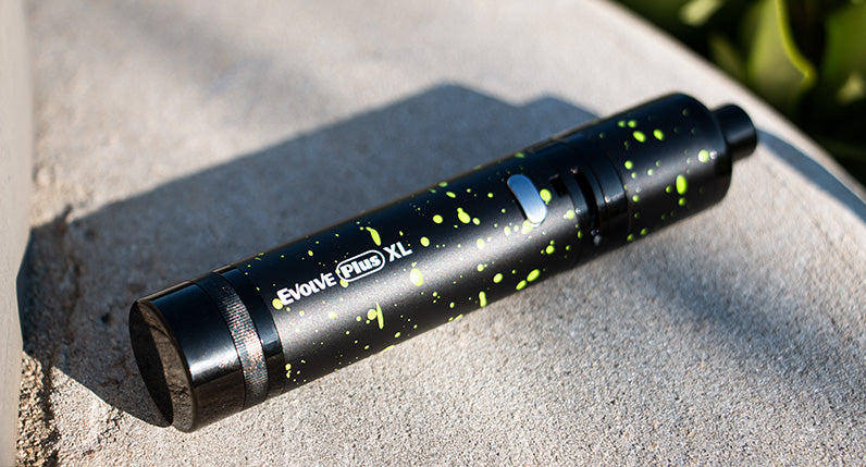 Wulf Evolve Plus XL Black with Green Spatter laying down on street lamppost