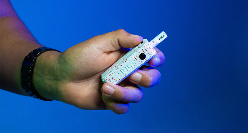 Man holding the Wulf UNI Max inside studio with blue lighting