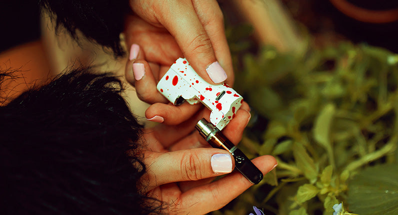 Woman holding the Wulf Micro Plus with the cartridge out near bushes