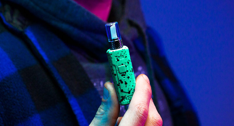 Person holding Wulf KODO Knife in front of blue/purple studio background