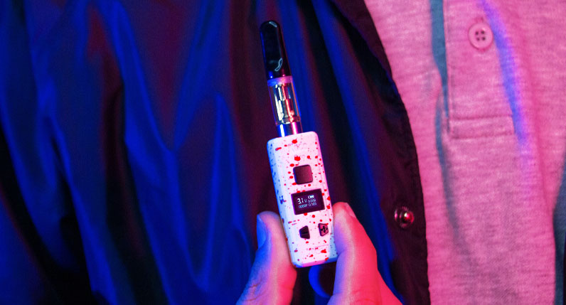 Person holding Wulf KODO Pro under blue and red studio lighting