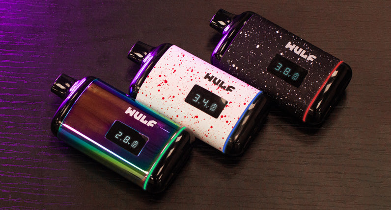 Vibrant color variations of the Wulf Recon vape set on a rustic wooden table