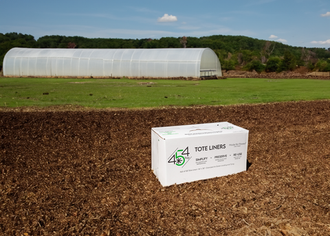 Durable tote liners ready for use outside a cannabis farm, essential for optimal post-harvest storage and Croptober preparations