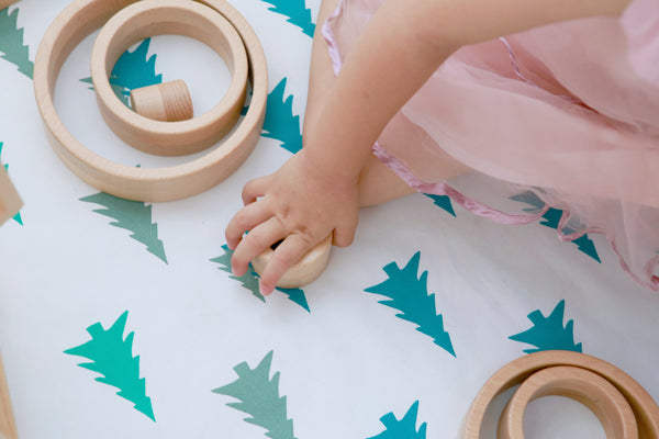 Young Child Playing With Educational Wooden Toy To Improve Fine Motor Skills