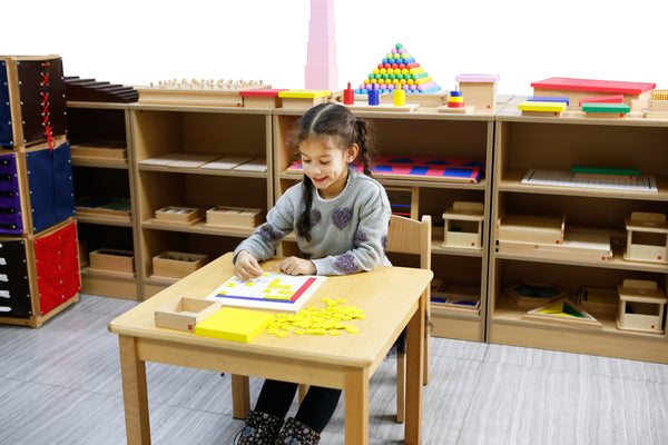 Young Child Using Montessori Resources To Learn