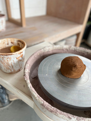 image of ball of clay on the wheel