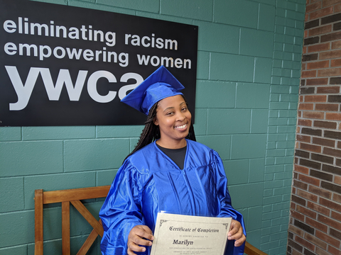 black woman smiling in graduation cap and gown