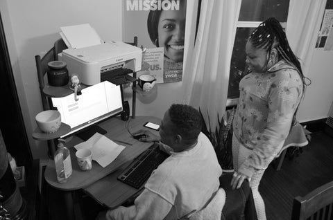 Two Labyrinth Handmade Goods apprentices working on project together at a computer desk.