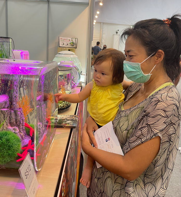A mother & her son are looking at BiOrb Water at Singapore Garden Festival 2022