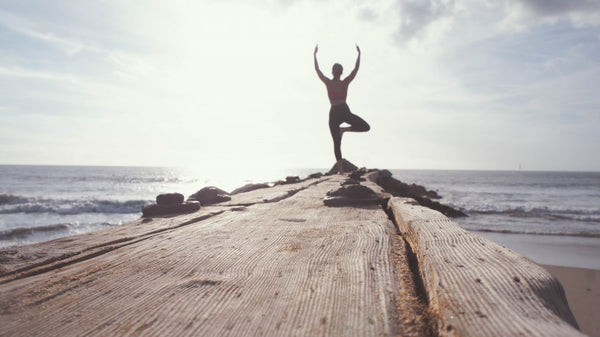 Practicing yoga on the deck in the morning