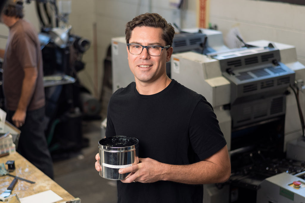 Scott Fulbright, Founder & CEO of Living Ink, Pictured holding a can of his algae-based ink.