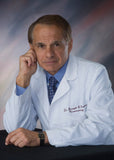 Dr. Joseph Maroon, Neurosurgeon, pictured in his white coat.